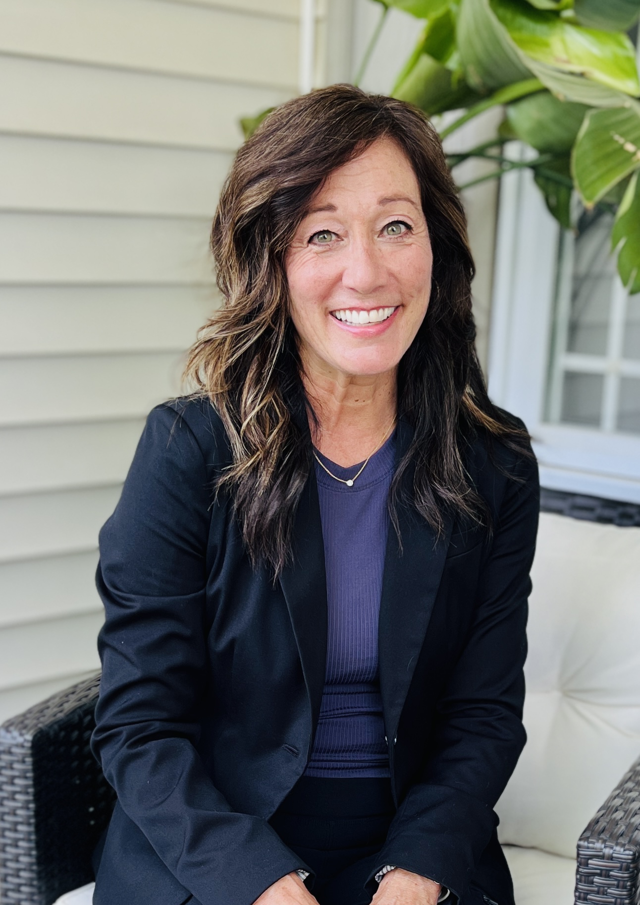 Kim Stuart smiling on a front porch